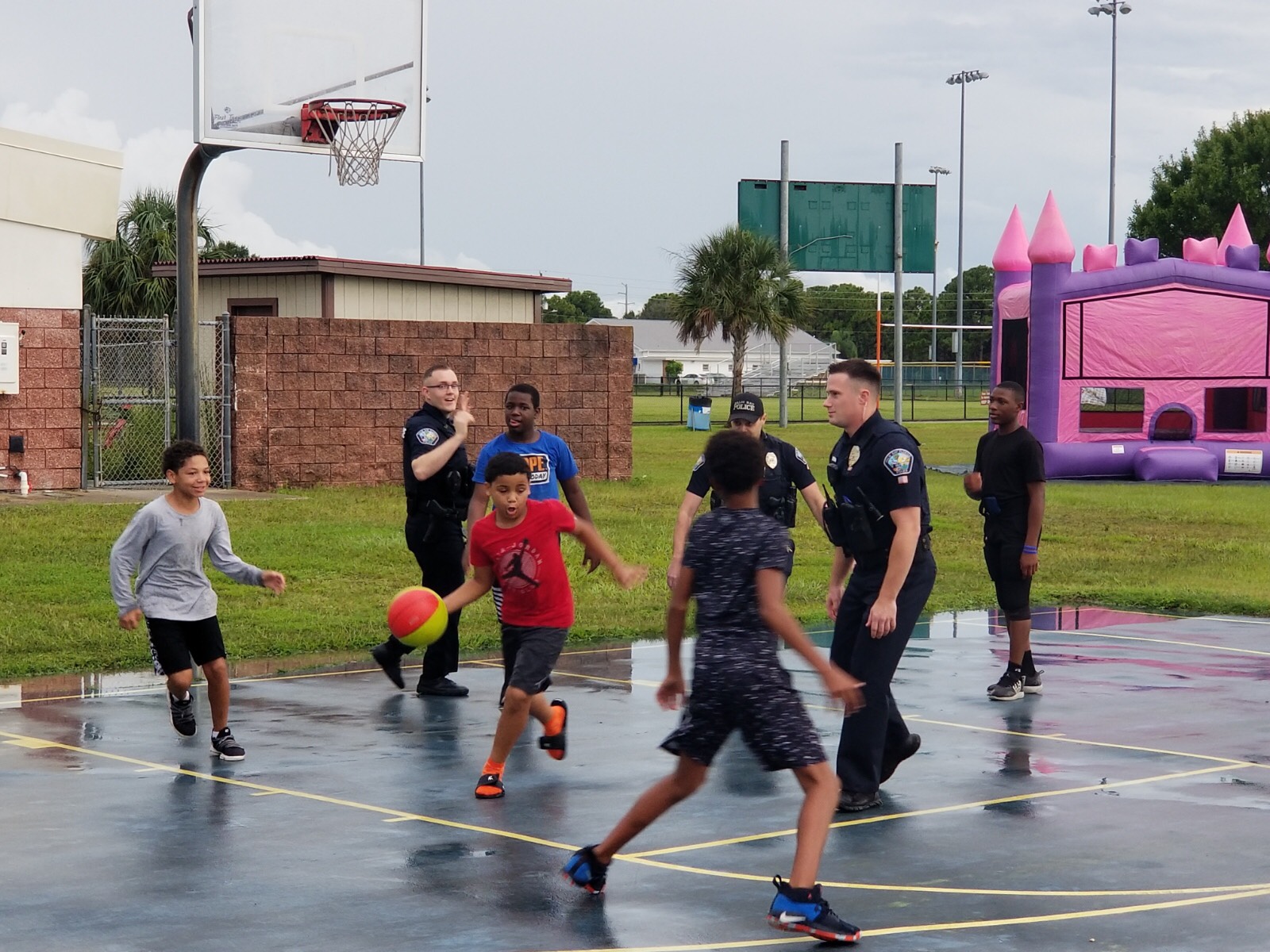 Kids and Officers playing basketball at National Night Out 2019