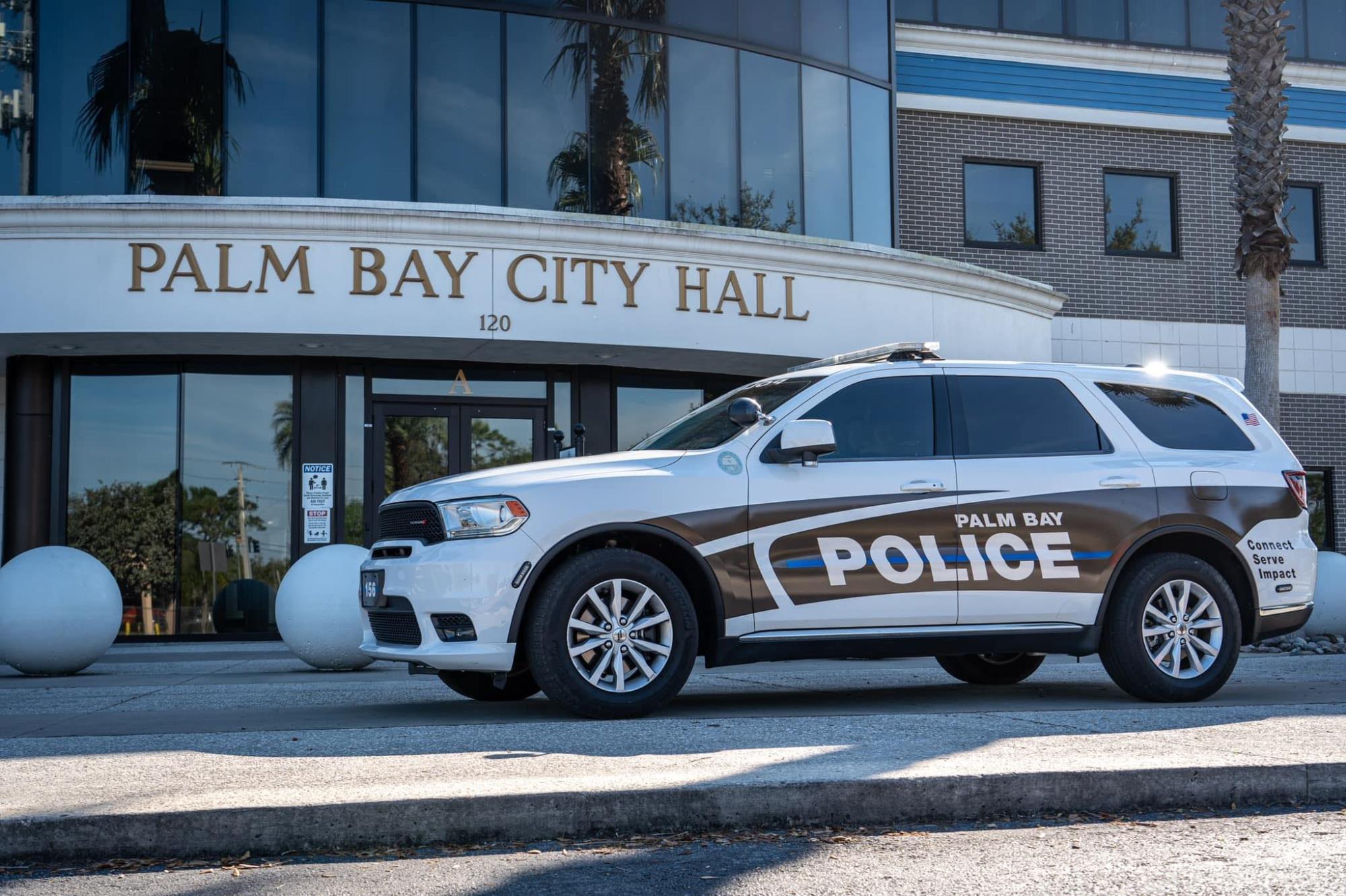 Patrol car with lights on in front of city hall